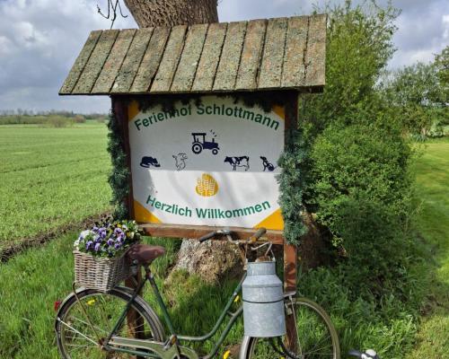 a bike parked next to a sign on a tree at Ferienhof Schlottmann in Achtrup