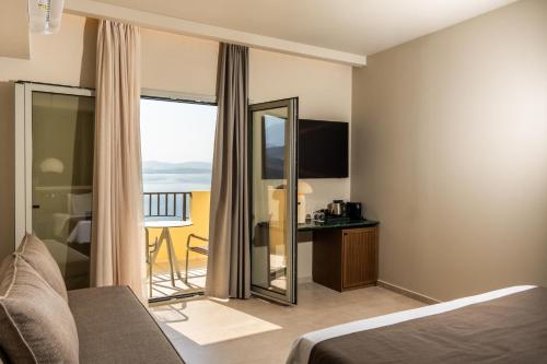 a hotel room with a bed and a mirror at Astoria Hotel in Agia Galini