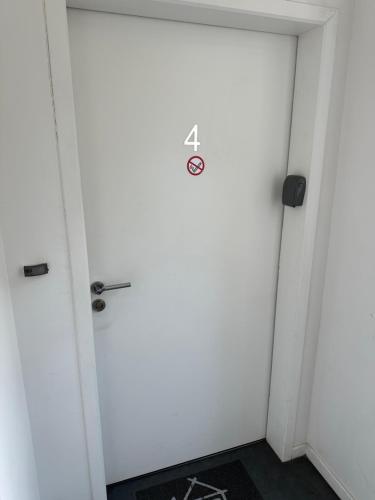 a door with a sign on it in a room at Charmant appartement RDC familial ou pour le travail in Uzerche