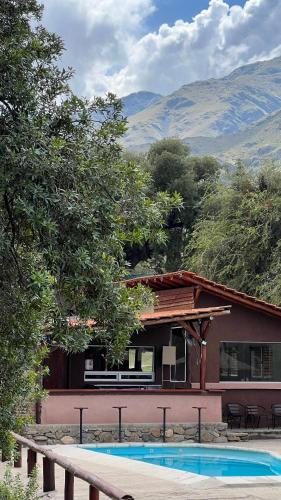 a house with a swimming pool in front of it at Tata Inti Complejo Serrano in Merlo