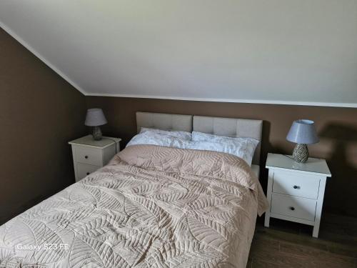 a bedroom with a large bed with two night stands at Kaszuby Punkt Klonowo Przywidz sauna klima basen in Przywidz