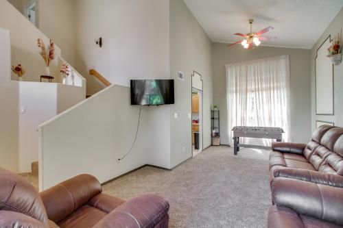 a living room with two couches and a flat screen tv at Explore ABQ and Rancho Rio Family Home with Patios! in Rio Rancho