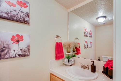 a bathroom with a sink and a mirror at Explore ABQ and Rancho Rio Family Home with Patios! in Rio Rancho