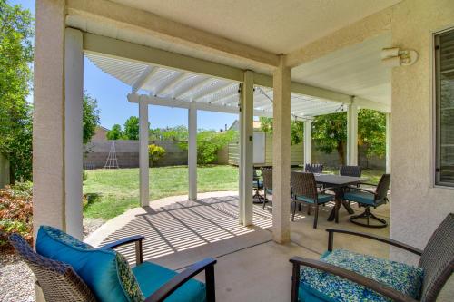 a screened porch with chairs and a table and a table and chairs at Explore ABQ and Rancho Rio Family Home with Patios! in Rio Rancho