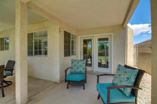 a porch with two chairs and a table at Explore ABQ and Rancho Rio Family Home with Patios! in Rio Rancho