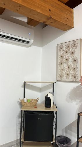 a counter in a room with a table with a microwave at Calatafimi Rocca Home in Palermo