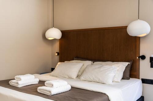 a bedroom with a bed with towels on it at Astoria Hotel in Agia Galini