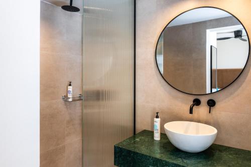 a bathroom with a sink and a mirror at Astoria Hotel in Agia Galini