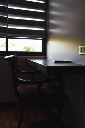 a desk with a chair in front of a window at Kunan Hotel in Cochabamba