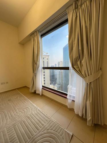 a large window with a view of a city at JBR Skyview Rooms in Dubai