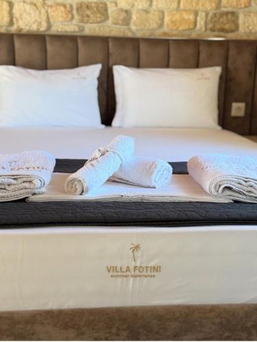 a bed with two rolled towels on it at Villa fotini in Kallithea Halkidikis