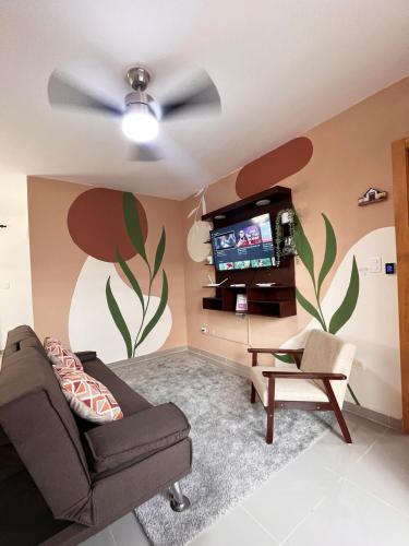 a living room with a couch and a tv at Apartment near the airport in Boca Chica