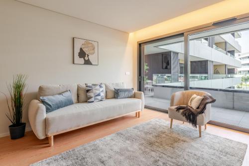 ヴィラ・ノヴァ・デ・ガイアにあるPremium Apartment w/ Garage & Balcony by HostWiseのソファと椅子のあるリビングルーム
