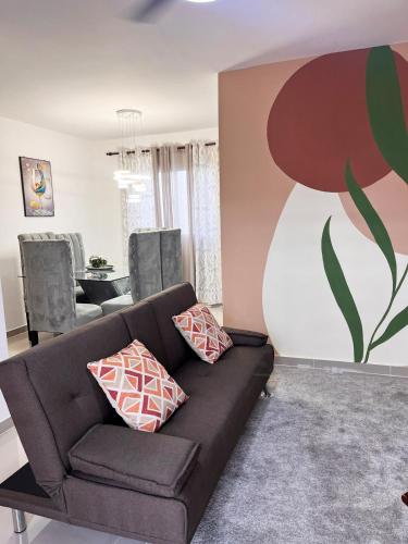 a living room with a couch and a painting on the wall at Apartment near the airport in Boca Chica