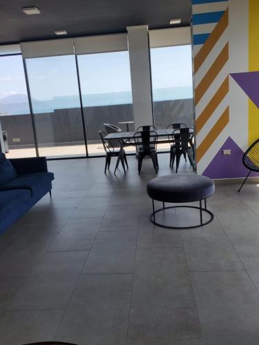 a room with a table and chairs and a couch at Entheos Hotel in Antofagasta