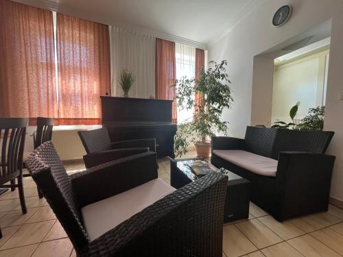 a living room with chairs and a piano at Aparthotel Mariazellerhof in Sankt Pölten