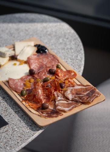 a pizza on a cutting board on a table at Radisson Hotel Reims in Reims
