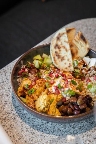 a bowl of food with beans and a tortilla at Radisson Hotel Reims in Reims