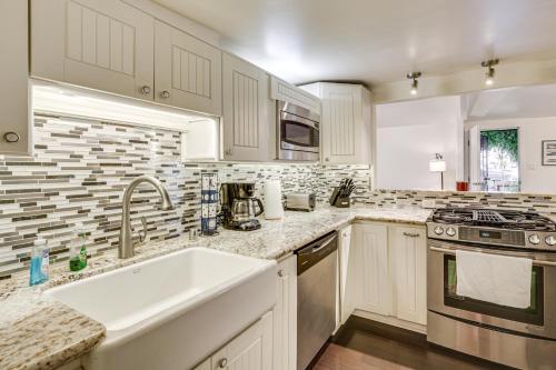 a white kitchen with a sink and a stove at 2 Mi to Ocean Pet-Friendly Imperial Beach Retreat in Imperial Beach