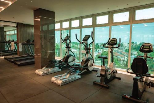 a gym with treadmills and exercise bikes in a building at Maison De Tabasa near Tops Cebu in Cebu City