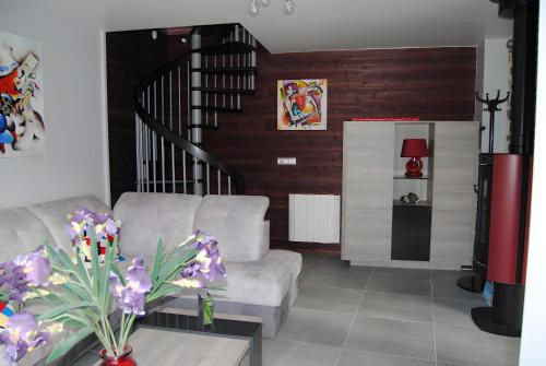 a living room with a couch and a table at Gite Des Taravelles in Manzat