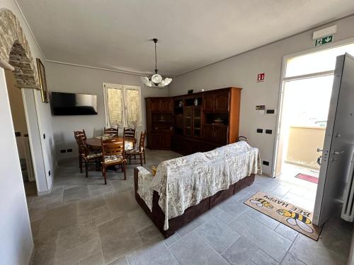 a living room with a bed and a dining room table at Casa in mezzo agli Ulivi in Lamporecchio