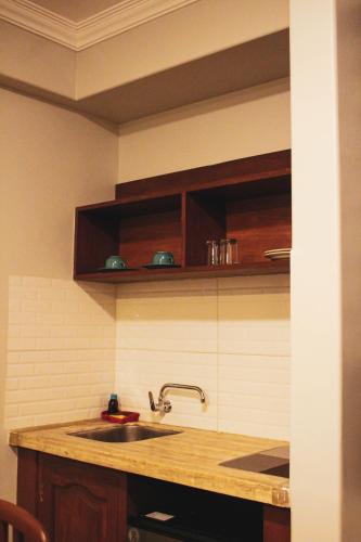 a kitchen with a sink and a counter top at Kunan Hotel in Cochabamba