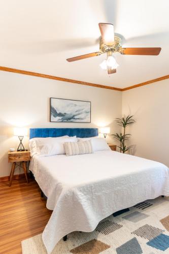 a bedroom with a large bed with a ceiling fan at 4 Beds ,King Bed, Tvs, Kids essentials, office, Grill, Crib, in Bond park ,PNC Arena in Cary