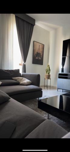 a living room with two beds and a couch at Luxury apartment in Muscat