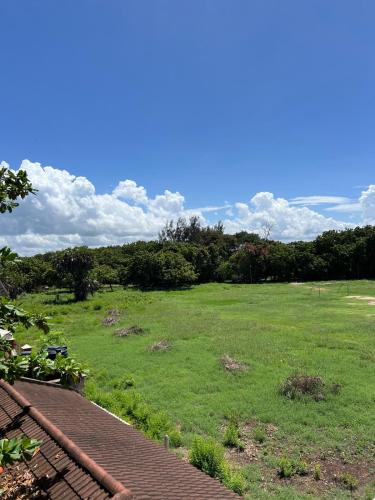 a large green field with trees in the background at 1bedroom Nyali in Nyali