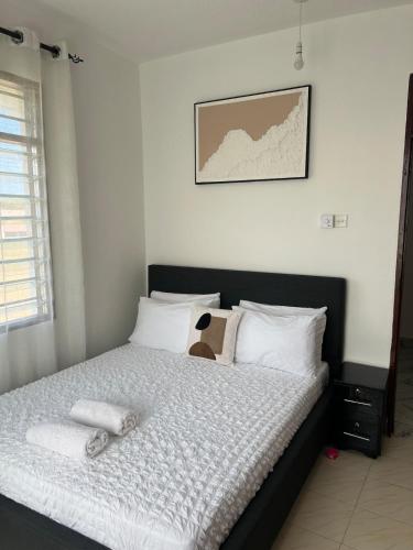 a bedroom with a bed with a stuffed animal on it at 1bedroom Nyali in Nyali