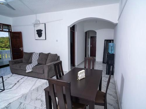 a living room with a table and a couch at 1bedroom Nyali in Nyali