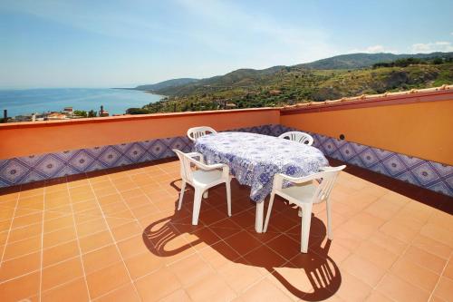 a table and chairs on a balcony with a view at Terrazza sul mare in Santo Stefano di Camastra