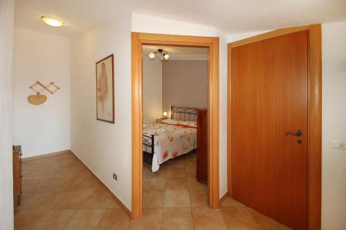 a room with a bedroom with a bed and a door at Terrazza sul mare in Santo Stefano di Camastra