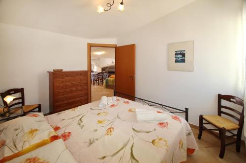 a bedroom with a bed with a floral bedspread at Terrazza sul mare in Santo Stefano di Camastra
