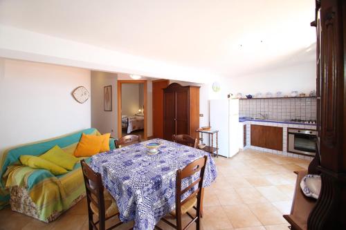 a living room with a table and a couch at Terrazza sul mare in Santo Stefano di Camastra