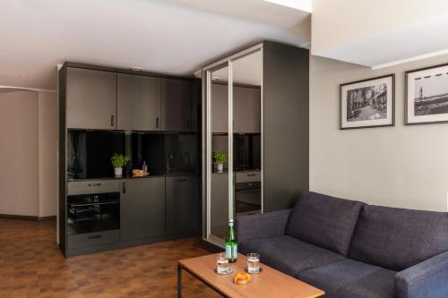 a living room with a couch and a table at Bob W Stockholm Gamla Stan in Stockholm