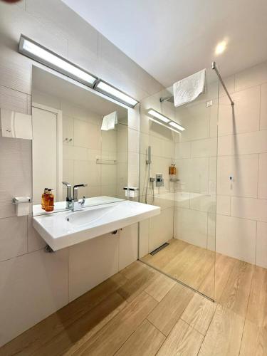 a large bathroom with a sink and a shower at Condo Studio Plaza in Budva