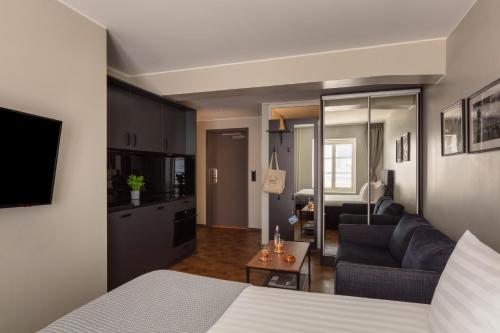 a hotel room with a bed and a living room at Bob W Stockholm Gamla Stan in Stockholm