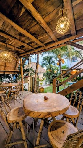 a wooden table and chairs on a patio at Nuevo NAYAL in Las Peñitas