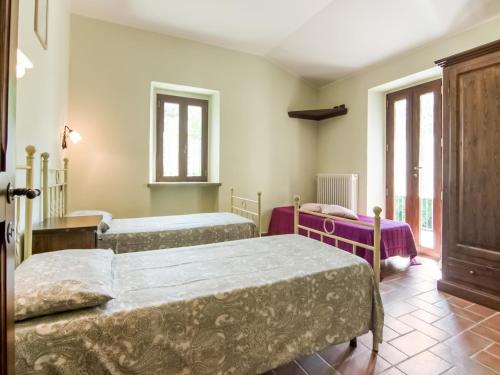a bedroom with two beds and a window at Villa in Tavoleto with pool in Tavoleto