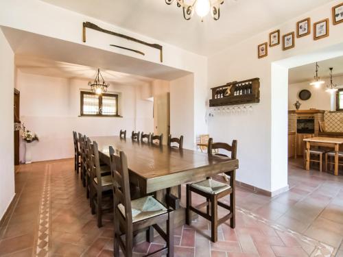 a dining room with a wooden table and chairs at Villa in Tavoleto with pool in Tavoleto
