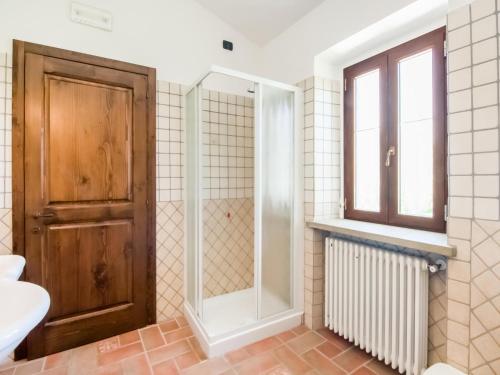 a bathroom with a shower and a glass door at Villa in Tavoleto with pool in Tavoleto