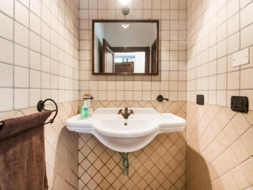 a bathroom with a white sink and a mirror at Villa in Tavoleto with pool in Tavoleto