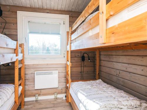 a bedroom with two bunk beds and a window at 10 person holiday home in Juelsminde-By Traum in Juelsminde