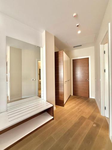 an empty room with a mirror and a wooden door at Condo Studio Plaza in Budva