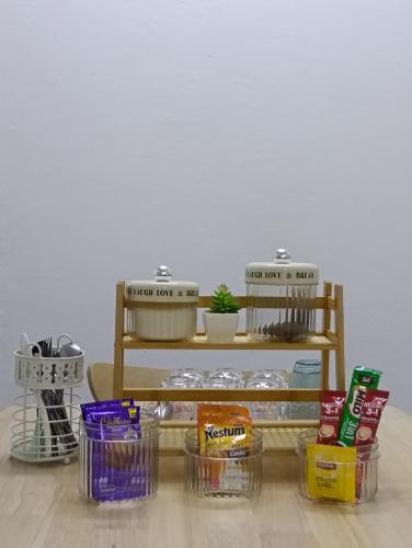 a shelf filled with containers of food on a table at Air Puteri Rest House in Mersing