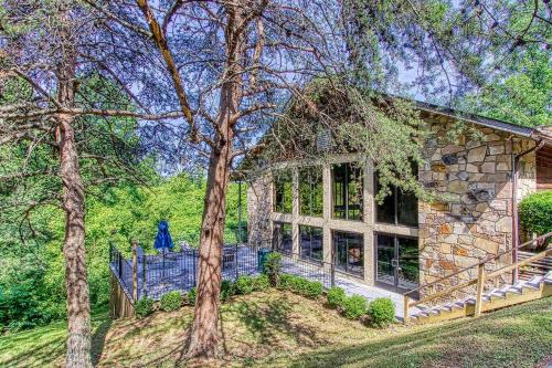 a large stone house with a large window at Relaxing Escape Pool Access & Close to Dollywood in Pigeon Forge