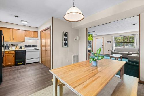 a kitchen and living room with a wooden table at Relaxing Escape Pool Access & Close to Dollywood in Pigeon Forge
