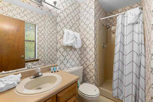 a bathroom with a sink and a toilet and a shower at Relaxing Escape Pool Access & Close to Dollywood in Pigeon Forge